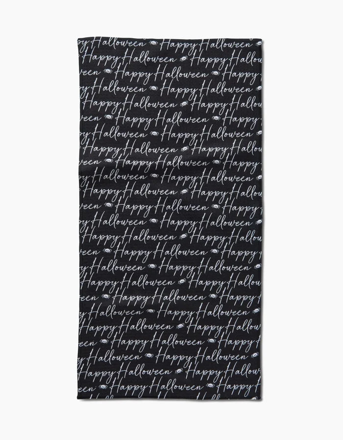 The Geometry Halloween Script Black towel is a black rectangular bar towel with “Happy Halloween” written repeatedly in white cursive across its surface.
