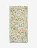 The Hawthorns Bar Towel by Danelys Sidron is rectangular, beige, and made from recycled materials, showcasing an all-over floral design with small orange flowers and green leafy vines, shown flat on a white background.