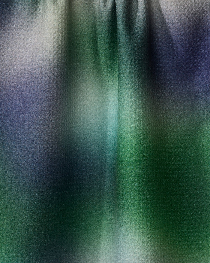 Haze" by Geometry features an abstract, textured glass design in green, blue, and gray tones, creating a blurred effect reminiscent of light through a recycled or patterned dish towel.