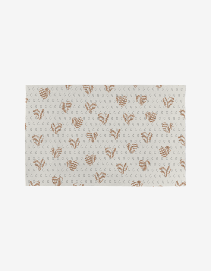 Heartbreaker by Hufton Studio is a rectangular white cloth featuring brown striped hearts and gray crescent shapes, made from post-consumer recycled materials for an eco-friendly towel alternative.
