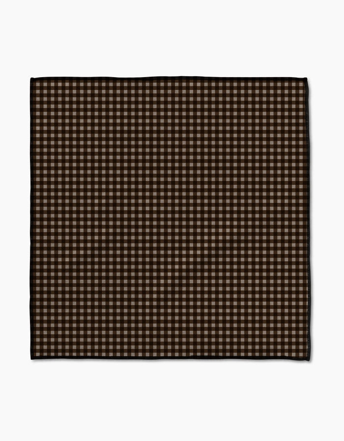 The Geometry Hearth Paw Towel features a brown and beige gingham checkered pattern. Ultra-absorbent and rectangular, its perfect for drying your dog after baths or rainy walks. Displayed flat against a white background.
