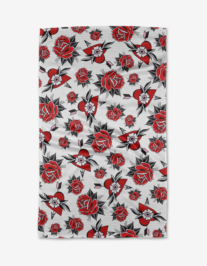 Hearts and Roses by Cole Strem features a white Geoweave fabric covered edge to edge with a dense repeating pattern of red and black roses and leaves.