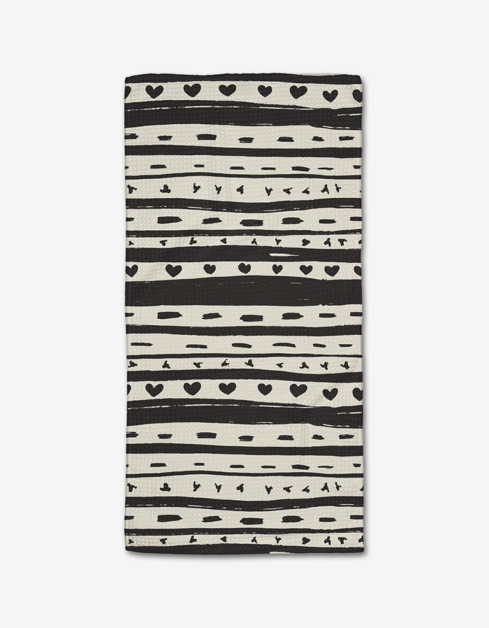 The Danelys Sidron Heartstring Bar Towel features black and white horizontal stripes with hearts, dots, and lines on a white background, crafted from ultra-absorbent Geoweave fabric.