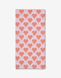 The Heartthrob bar towel by Charlie Rowan Designs features a light pink Geoweave fabric with evenly spaced red hearts outlined in white rays, creating a bold all-over pattern.