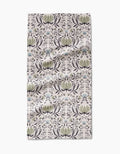 The Hello Flowers Bar Towel by Amita Nair is crafted from ultra-absorbent Geoweave fabric, featuring a green, blue, and black floral pattern on light beige. Rectangular with light wrinkles, its shown on a white surface.