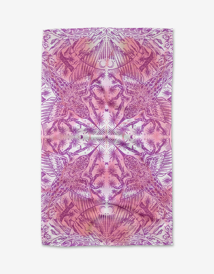 The Hummingbird tea towel by Skye Walker is made from quick-drying recycled materials and showcases a magenta and pink symmetrical pattern with stylized birds, plants, and abstract shapes in a mirrored, kaleidoscopic design.