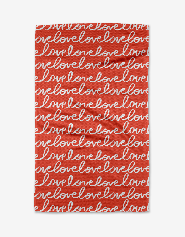 The Kayla Ann Infinite Love tea towel is rectangular and red, with love repeated in white cursive rows. This absorbent, quick-drying towel adds a heartfelt touch to your kitchen.