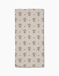 The Cole Strem Inked Bloom Bar Towel is beige and rectangular, featuring a grid of black line-drawn flowers and dots. Crafted from Geoweave fabric, it offers exceptional durability and absorbency.