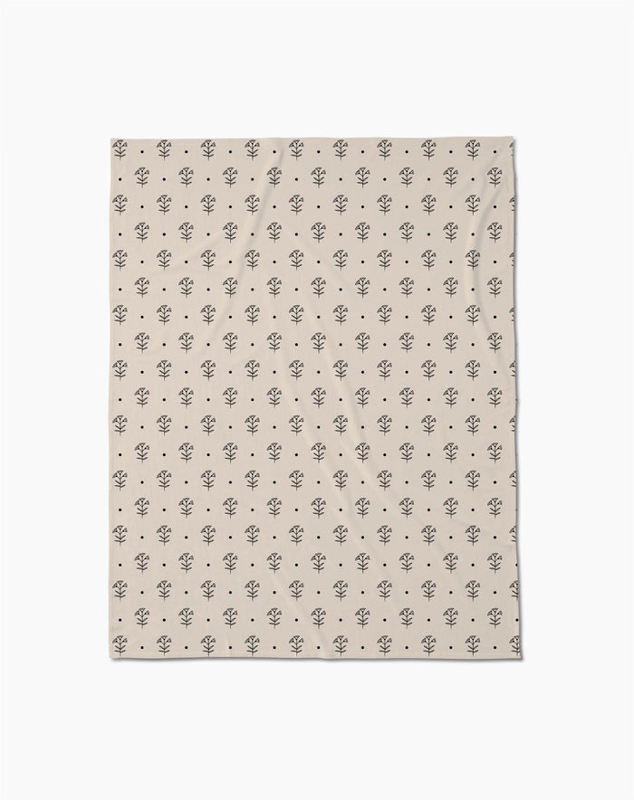 Inked Bloom by Cole Strem is a beige Butter Blanket with a repeating pattern of small, simple black tree illustrations, crafted from eco-friendly recycled materials.