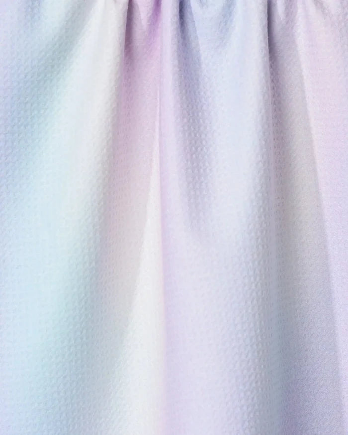 Close-up of the GEOMETRY Iridescence tea towel, featuring pastel hues of light blue, pink, and purple with a textured finish. The ultra-absorbent kitchen towel has soft folds and is gently gathered at the top.
