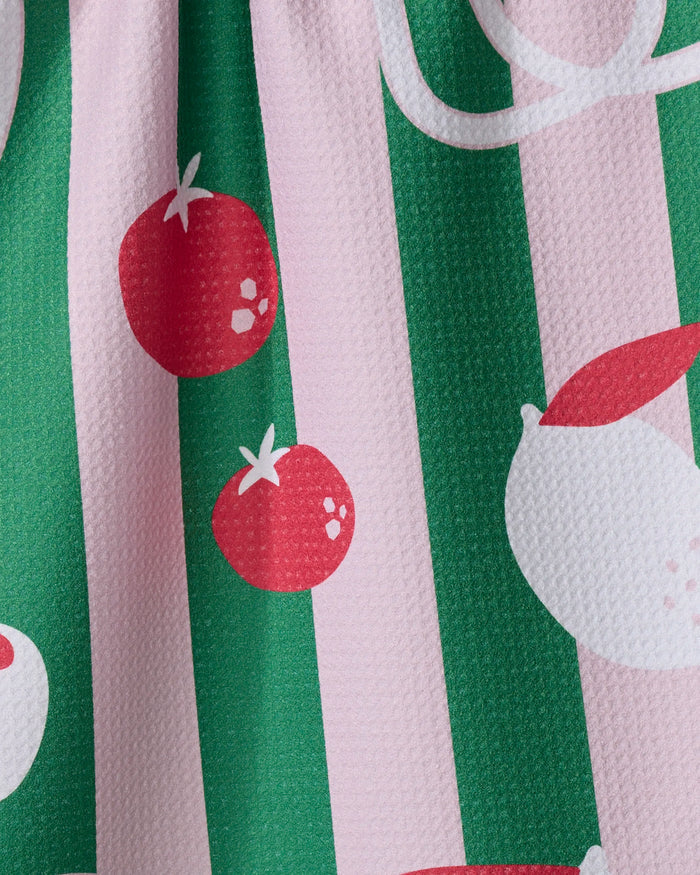 The Italian Mood tea towel by Marina Solodka features a playful, colorful design with red tomatoes and white lemons on pink and green stripes, plus a slightly dimpled texture for added dimension.