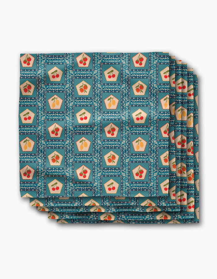 A folded Geosuede fabric cloth from Geometry, featuring the Italian Tiles design with a repeating pattern on a blue geometric background—perfect as a Dinner Napkin Set.