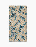 The Janine bar towel by Amy MacCready features a bold floral pattern with beige flowers, dark blue leaves, and a teal background. Made of ultra-absorbent Geoweave fabric for full-surface coverage and efficient drying.