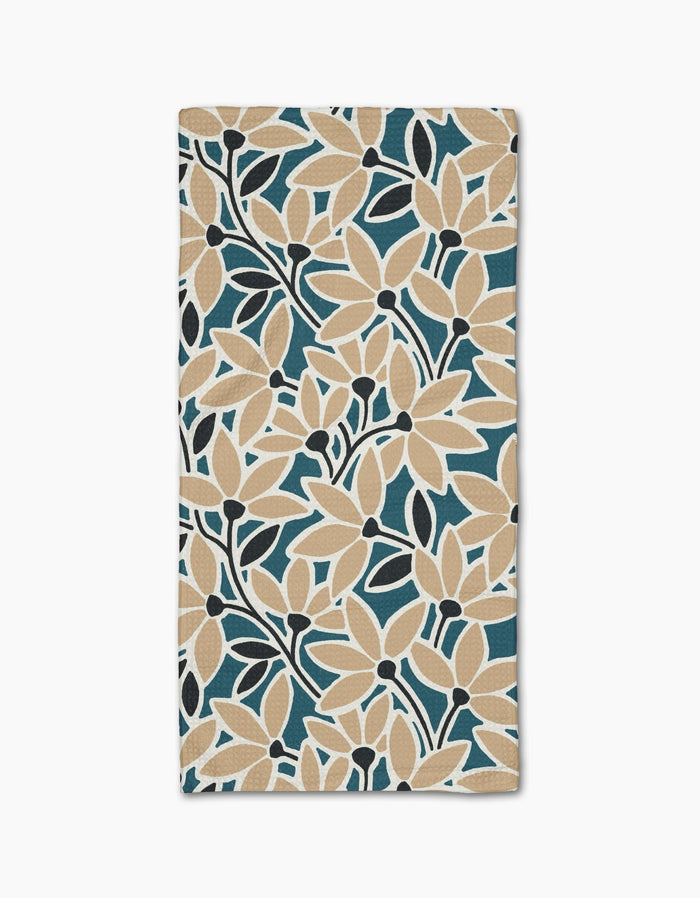 The Janine bar towel by Amy MacCready features a bold floral pattern with beige flowers, dark blue leaves, and a teal background. Made of ultra-absorbent Geoweave fabric for full-surface coverage and efficient drying.