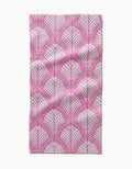 The Jaskin Bar Towel by Amy MacCready features rectangular Geoweave fabric with a pink fan-like geometric pattern on white, accented by thin radiating lines. Slight creases and folds are visible.