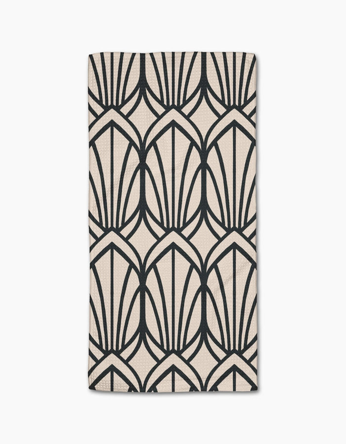 The Amy MacCready Jocelyn bar towel is beige, rectangular, made from Geoweave fabric, and features a bold black geometric pattern of stylized fan shapes or arches.