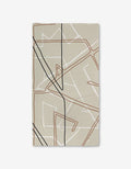 The GEOMETRY Journey rug features a rectangular beige design with abstract, overlapping lines in black, brown, and white on a plain background—crafted from recycled materials for an eco-friendly touch.