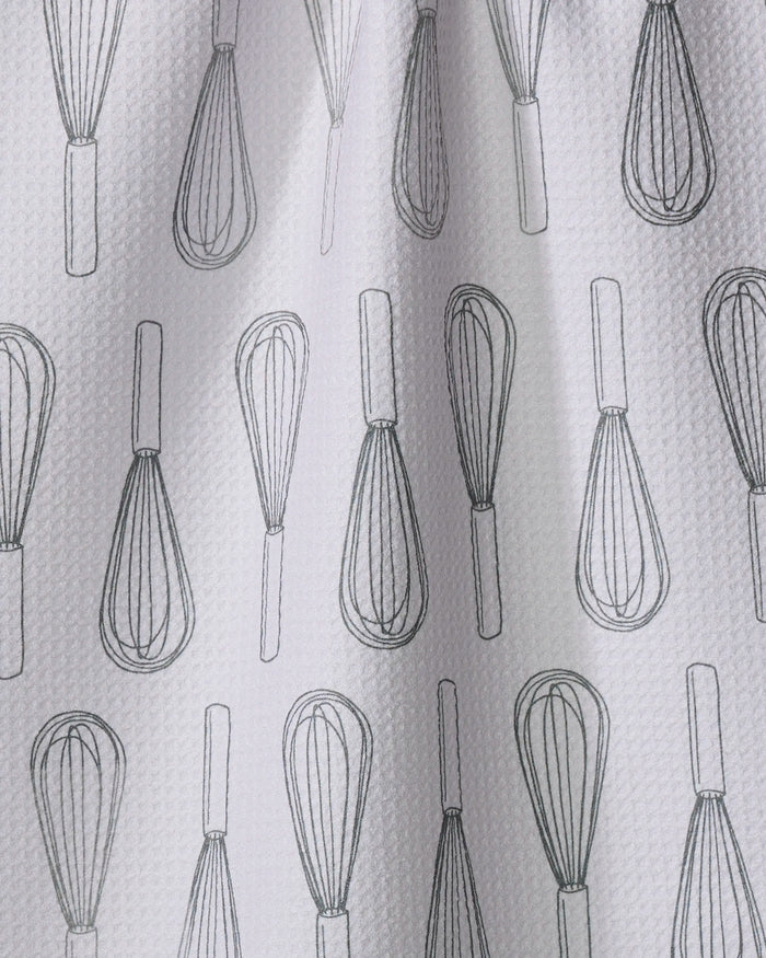 The Rosa Kichline Kitchen Whisks tea towel features a textured white design with black outlined whisks in neat vertical rows, made from quick-drying recycled materials.