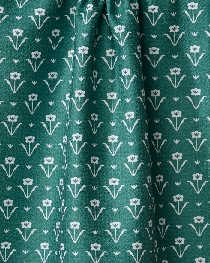The Buy Guide's Ladylake - Evergreen dish towel features absorbent green recycled fabric with a repeating white floral pattern, stylized flowers in rows, and soft center-gathered folds for an elegant kitchen accent.