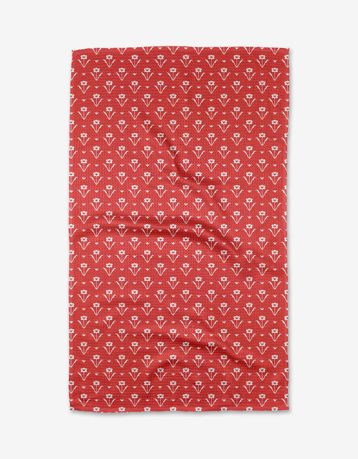 The Buy Guides Ladylake - Red: A red rectangular Kitchen Tea Towel in Geoweave fabric with a repeating white floral or geometric pattern, slightly wrinkled and laid flat on a white background.