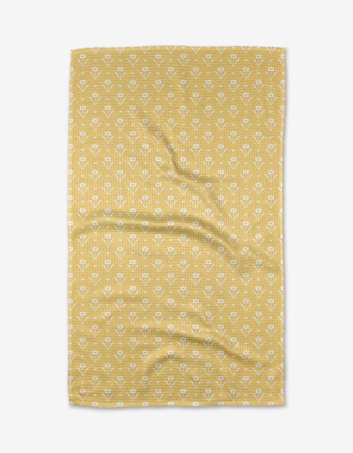 The Buy Guides Ladylake - Yellow tea towel is a yellow rectangular Geoweave fabric with a repeating small white floral pattern, shown with light wrinkles and laid flat on a white background.
