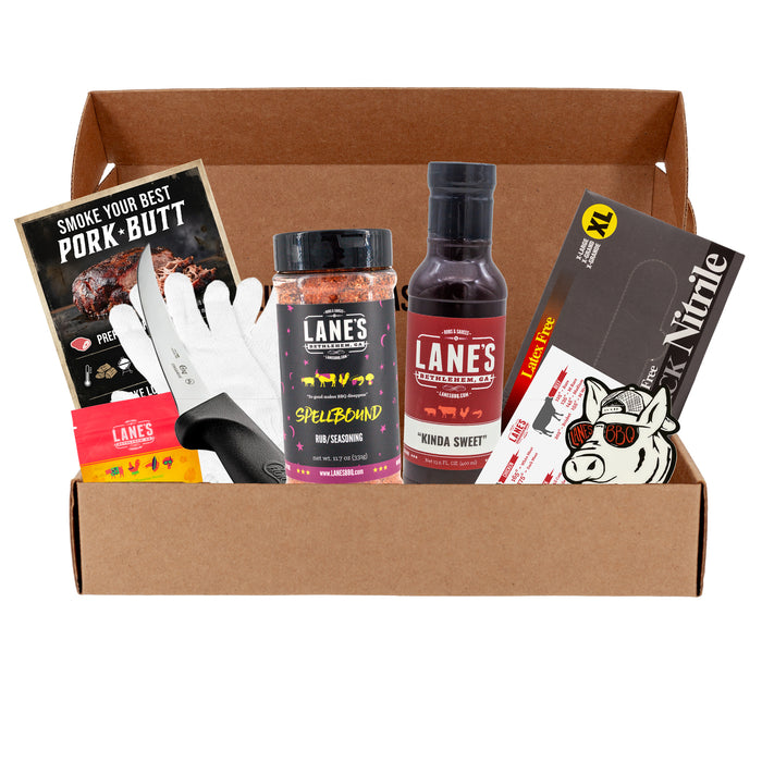 Box containing Lanes BBQ products including seasoning packets, bottles, and a knife.