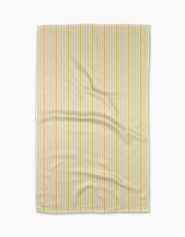 The Geometry Lemon Ice Geoweave fabric features light yellow and white vertical stripes, displayed flat with minor wrinkles on its ultra-absorbent surface, set against a white background.