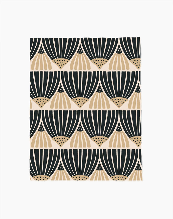 Letitia Dark by Amy MacCready features a repeating geometric pattern with black and beige fan-shaped designs on white in horizontal rows. Made from eco-friendly materials, it beautifully blends style with sustainability.