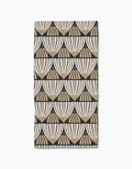 The Letitia Bar Towel by Amy MacCready features a repeating beige and black fan-shaped geometric pattern on a white background, crafted from durable Geoweave fabric.