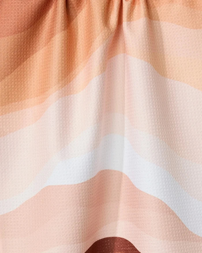 The Levels of Fall tea towel by GEOMETRY features soft, wavy stripes in peach, cream, and white. Made with Geoweave technology, it’s super absorbent with a subtle texture and gentle folds for a relaxed look.