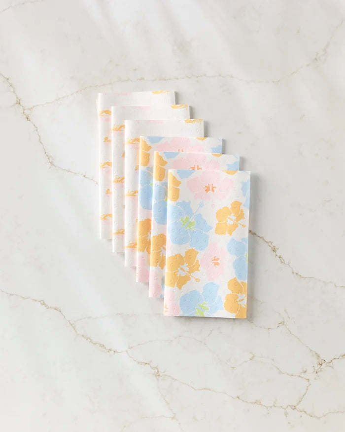 Seven Lobster Love napkins by GEOMETRY, featuring a red lobster print on eco-friendly paper towels, are neatly fanned out on a white marble surface with light brown veining.