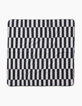 The Hufton Studio Long Check is a square blanket made from recycled materials, with a black and white vertical check pattern. Its ultra-absorbent fabric looks soft and slightly wrinkled, shown flat against a white background.