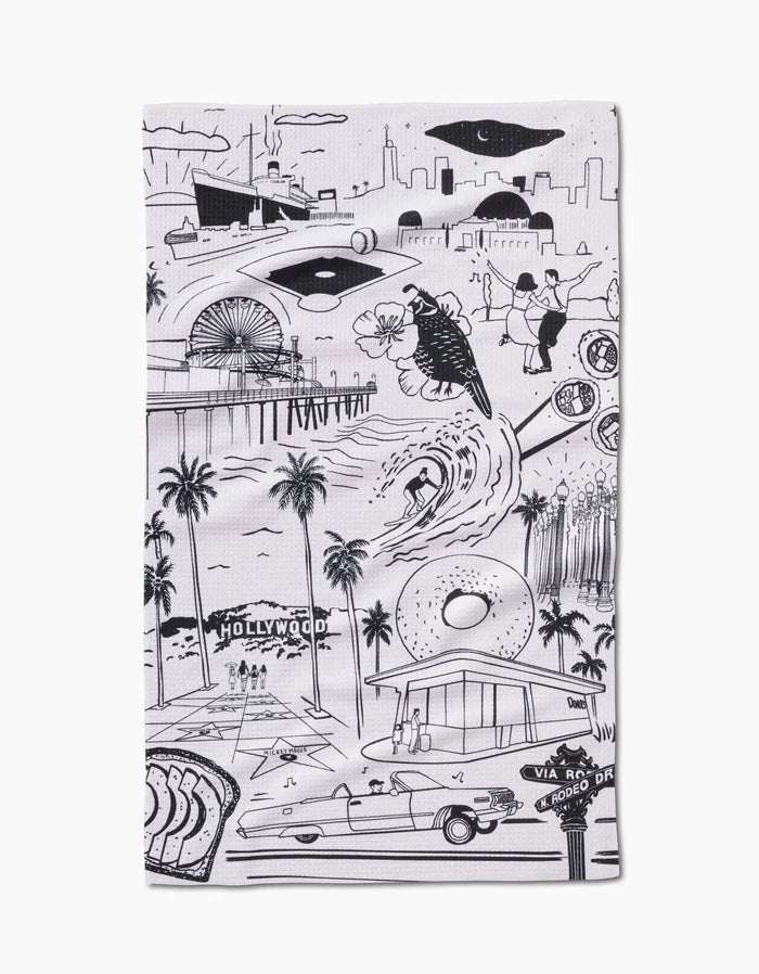 Los Angeles Tea Towel by Elisabeth Wing showcases black and white illustrations of city landmarks on soft Geoweave™ fabric made from recycled materials.