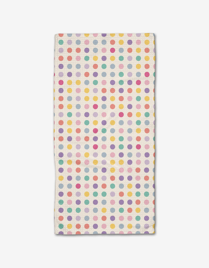 The Lots of Dots Bar Towel by Rebecca Bobko is a rectangular white towel with yellow, pink, red, purple, and teal polka dots in a colorful pattern, made from durable Geoweave fabric.