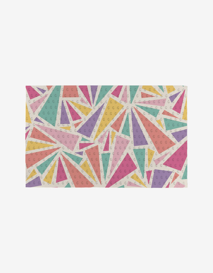 “Lots of Dots” by Rebecca Bobko features an eco-friendly, reusable material with colorful geometric triangles and pastel circles—pink, yellow, green, purple, and orange—on a white background.