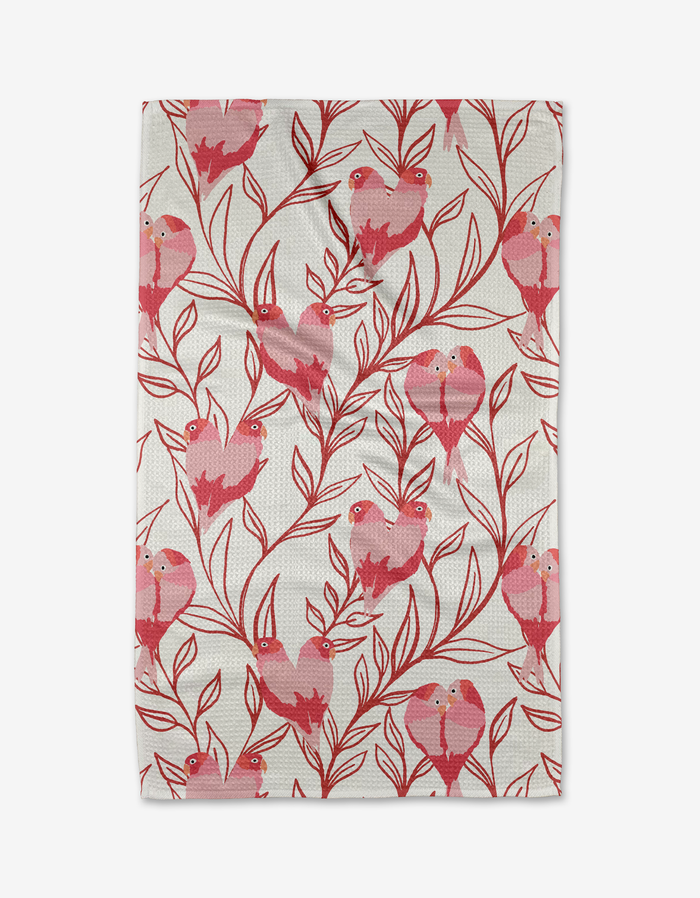 Add playful charm and eco-friendly style to your kitchen with the Love Birds tea towel by Hufton Studio, featuring a hand-drawn red and pink bird pattern on leafy branches. Made from recycled materials and set against a white background.