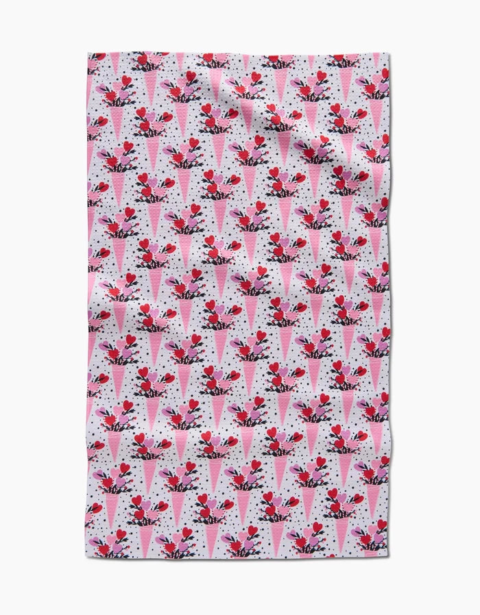 The Love Bouquet recycled kitchen towel by Charlie Rowan Designs features a pattern of pink and red ice cream cones with cherries on a white background with black dots.