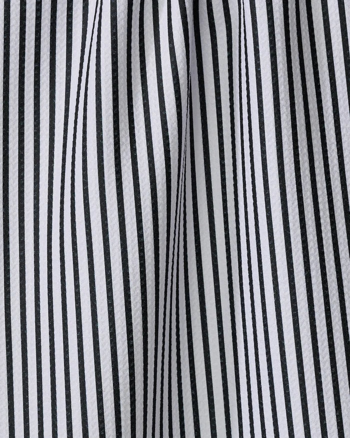 Close-up of the Love Notes tea towel by Kailee Wright, featuring black and white vertical stripes. Made from recycled materials, the fabric is gently draped, creating soft folds and shadows between the stripes.
