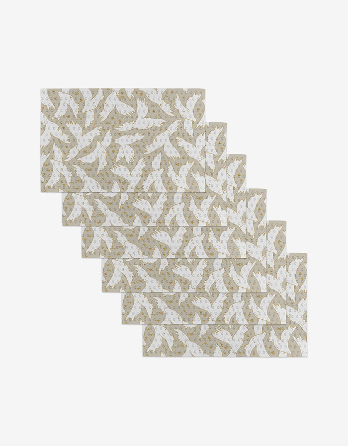Set of ten Love Takes Flight reusable kitchen towels by GEOMETRY, featuring a staggered arrangement of white birds and gold stars on a beige background.