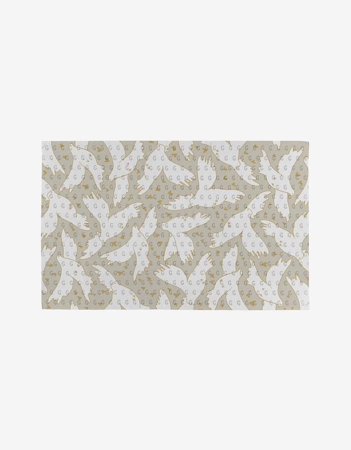 The GEOMETRY Love Takes Flight rug features white birds in various directions and crescent moons on a beige background, crafted from post-consumer recycled materials for an eco-friendly touch.