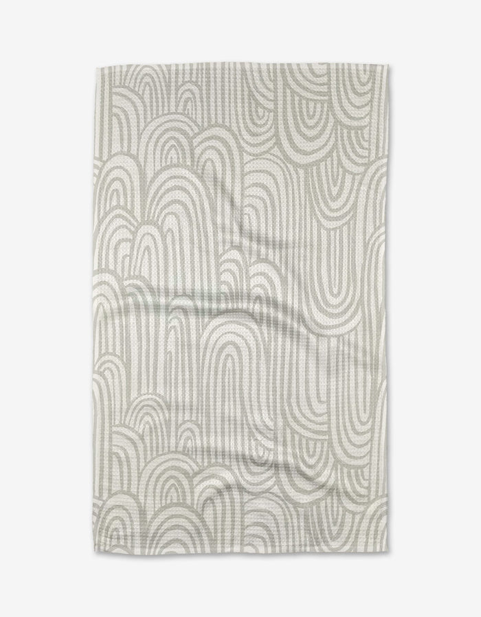 The Lovers Arc tea towel by Hufton Studio features an abstract pattern of overlapping light gray arches on a white background. Made from ultra-absorbent, slightly wrinkled fabric, it offers a casual and modern touch to your kitchen.