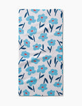 The Hufton Studio Luca Daisy is a rectangular white bar towel showcasing blue flowers with red centers and dark blue leaves, all on absorbent Geoweave fabric for stylish function.