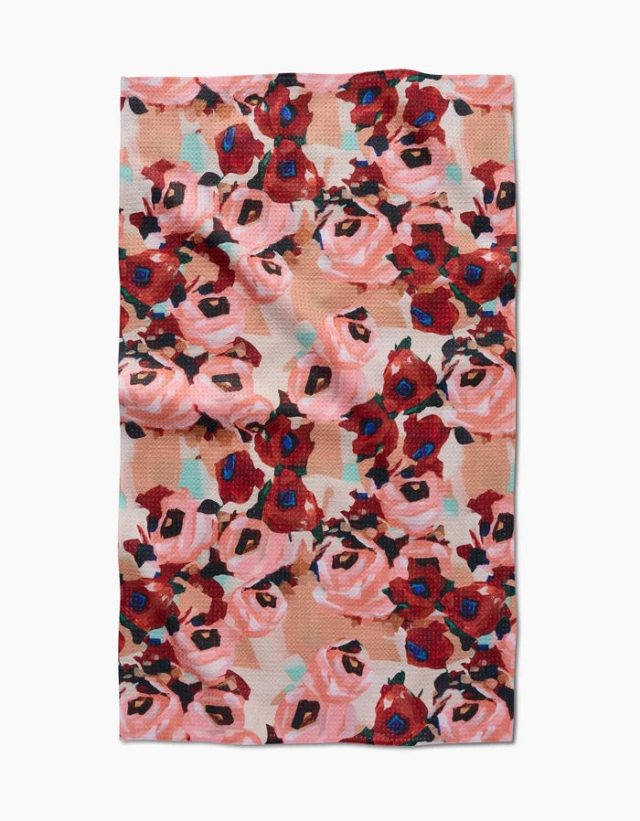The Lucia Tea Towel by Ania Zwara Art features a vibrant abstract floral design in red, pink, and blue on a light background, crafted with Geoweave™ fabric for excellent absorbency and durability.