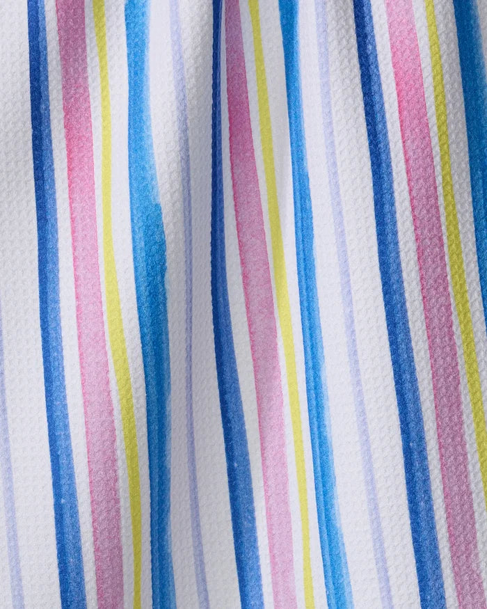 The Macarons in Paris Stripe tea towel by Travel Write Draw (Meagan Morrison) features hand-painted style blue, pink, yellow, and purple stripes on textured white fabric for a vibrant yet practical kitchen accent.