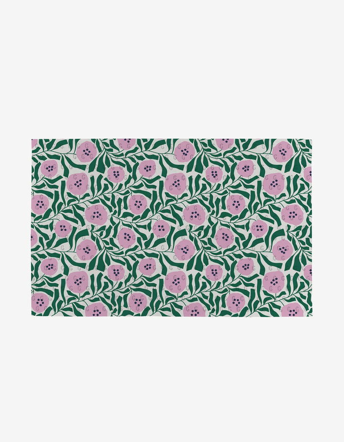 Magic Field by Happy Hemera features a vibrant, dense pattern of pink flowers with dark centers and green leaves on white—an eco-friendly alternative to paper towels made from post-consumer recycled materials.