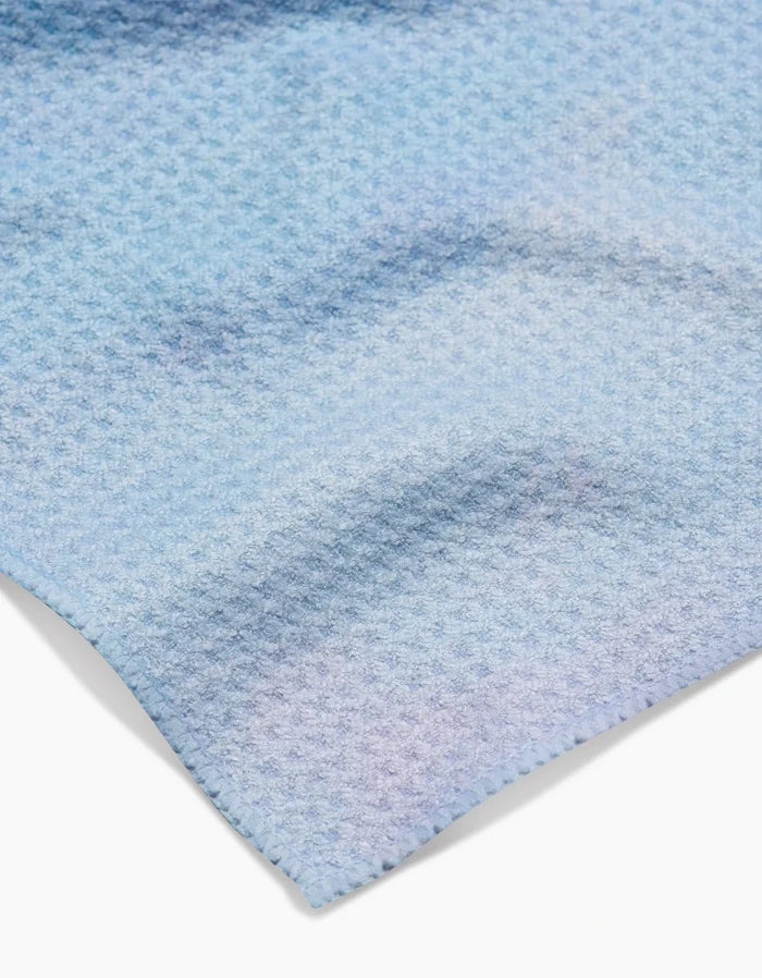 A close-up of the Stefanie Bales Magic In The Sky Bar Towel, crafted with Geoweave™ fabric and a waffle-like texture, softly folded on a white surface.