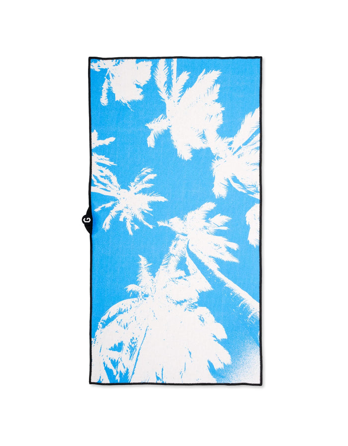 The GEOMETRY Magna - Blue Palms is a blue, ultra-absorbent rectangular towel with white palm tree silhouettes and a black border—ideal as a fitness towel for your beach or workout sessions.