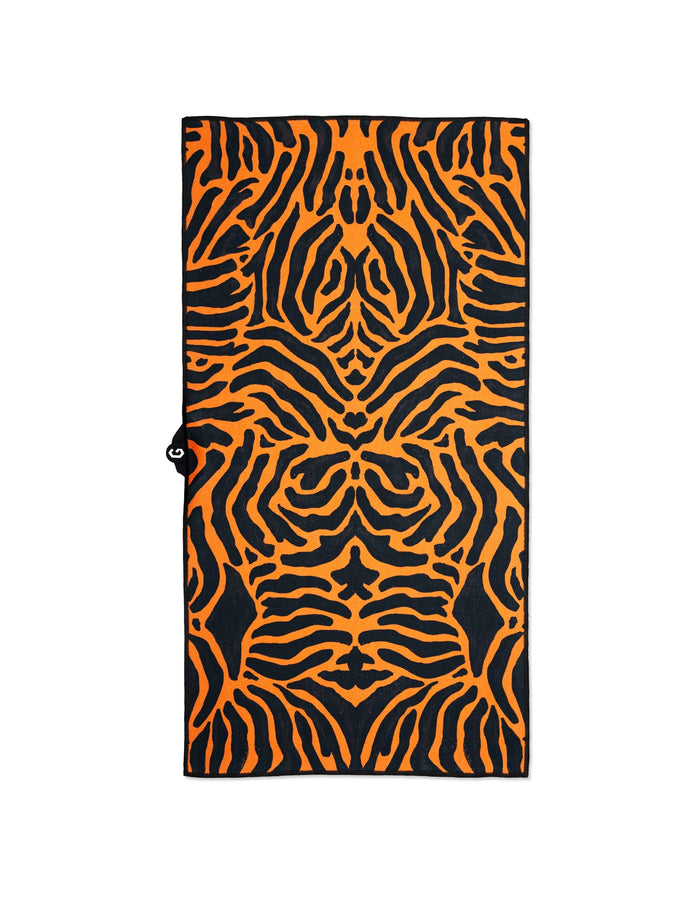 GEOMETRY’s Magna - Tiger towel features a bold, symmetrical orange and black tiger stripe design, made from recycled materials for ultra-absorbency. Shown laid flat on a white background.