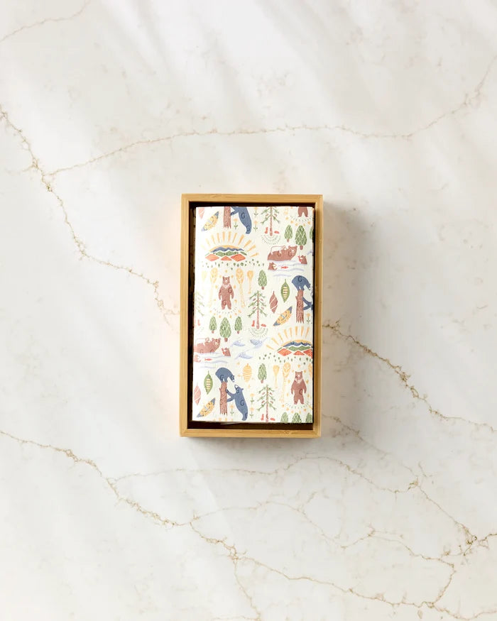 The Mama Bear by Elisabeth Wing is a rectangular box with a playful animal-patterned lid featuring bears, trees, and suns, perfect for storing your eco-friendly paper towels. It sits on white marble with light brown veining.