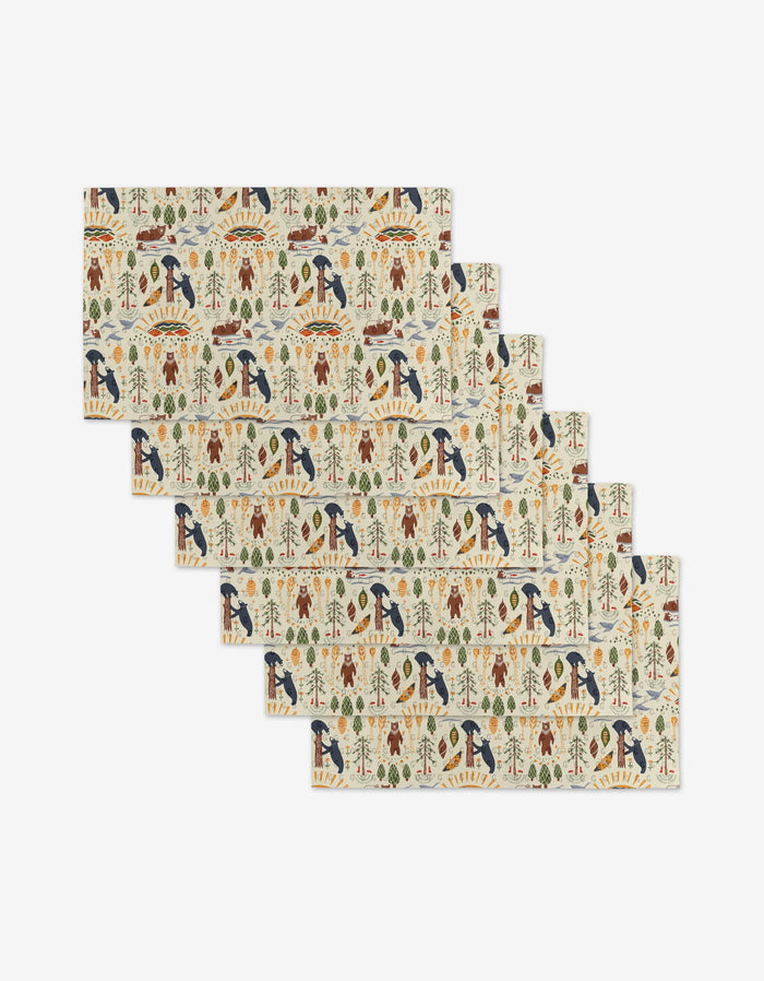 The Mama Bear placemats by Elisabeth Wing are a set of six rectangular mats, each with colorful nature patterns—birds, trees, leaves, and animals on a light background—crafted from environmentally friendly materials.